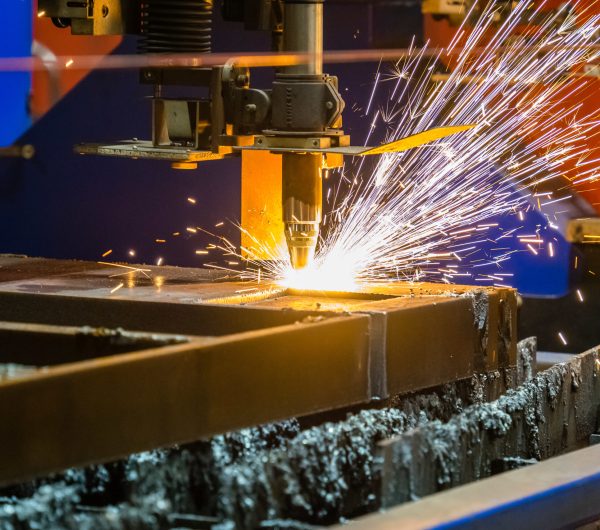 A closeup shot of sparks flying from an industrial steel cutter